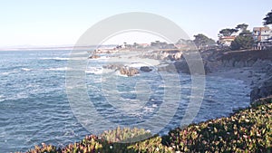 Rocky craggy ocean beach, sea waves crashing on shore, Monterey California coast