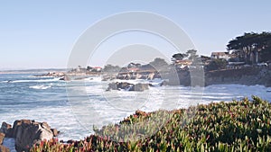 Rocky craggy ocean beach, sea waves crashing on shore, Monterey California coast