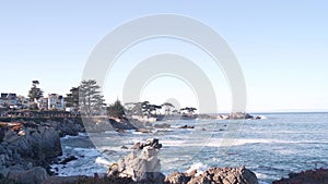 Rocky craggy ocean beach, sea waves crashing on shore, Monterey California coast