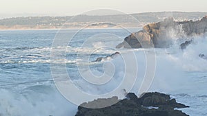 Rocky craggy ocean beach, sea waves crashing on shore, Monterey California coast