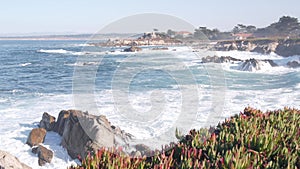 Rocky craggy ocean beach, sea waves crashing on shore, Monterey California coast