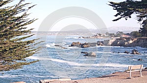 Rocky craggy ocean beach, sea waves crashing on shore, Monterey California coast