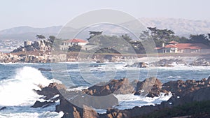 Rocky craggy ocean beach, sea waves crashing on shore, Monterey California coast