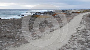 Rocky craggy ocean coast, Monterey California. Footpath walkway or footway trail