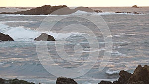 Rocky craggy ocean coast, sea water waves crashing on rocks, Monterey California