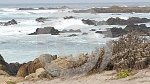 Rocky craggy ocean coast, sea water waves crashing on rocks, Monterey California