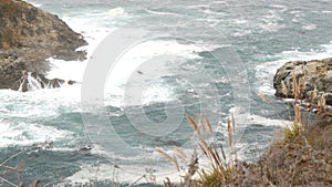 Rocky craggy ocean, foggy weather. Waves crashing on beach. California, Big Sur.