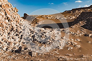 Rocky dunes and dark brown sand in Atacama desert. Chile
