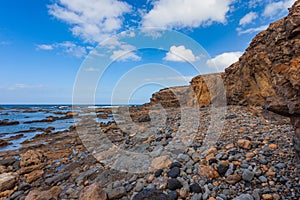 rocky escarpments that fall into the sea at Tebeto Beach in the municipality of La Oliva photo