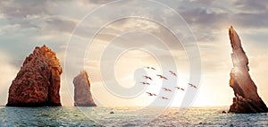 Rocky formations on a sunset background. Famous arches of Los Cabos. Mexico. Baja California Sur. Panoramic image.