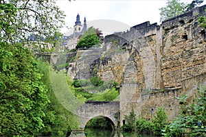 The rocky fortification in Luxembourg City and bridge over Alzette river.