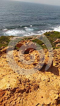 Rocky goldish cliff Atlantic Ocean