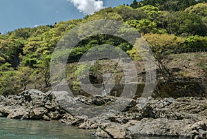 Rocky green hills along Hozugawa River.