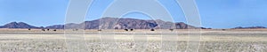 rocky hills and colorful flatland in Naukluft desert, near Garub, Namibia