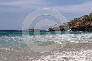 The rocky island of Pulau Paus, looking like a big whale, is covered with dry grass and tropical vegetation. photo