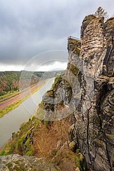 Rocky landscape of Saxon Switzerland national park, the Elbe river and Sandstone Mountains on stormy day Germany