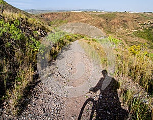 Rocky landscape and silhouette of cyclist