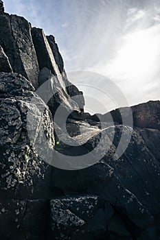 Rocky landscape with the sun shining through the clouds in the sky