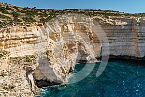 Rocky limestone coastline of Gozo island and Mediterranean Sea with turquoise blue water and caves.Great spot for hiking along