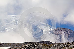 rocky lookout in front of mountain glacial field