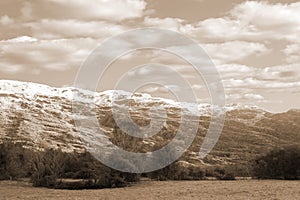 Rocky mountain and fields countryside snow scene