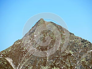 Rocky mountain peak Piz Murterchoembel (2998 m) in the massif of the Albula Alps above the Swiss road pass Fluela