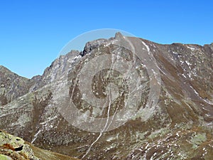 Rocky mountain peak Piz Murterchoembel (2998 m) in the massif of the Albula Alps above the Swiss road pass Fluela