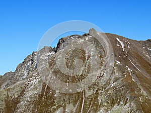 Rocky mountain peak Piz Murterchoembel (2998 m) in the massif of the Albula Alps above the Swiss road pass Fluela