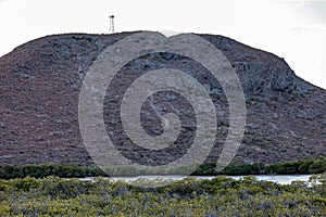 Rocky mountain with a telecommunication tower on top of Mexican landscape