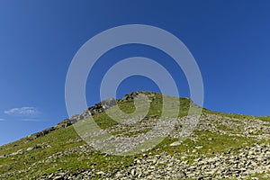 Rocky mountain top with grass and stone