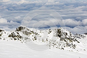 Rocky mountain top in snow cloudy