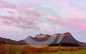 Rocky mountain wilderness with soft pinky orange sky