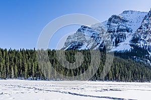 rocky mountains around frozen lake louise winter wonderland