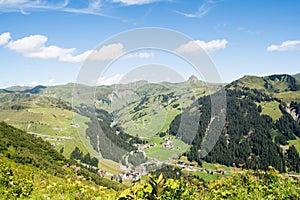 Rocky mountains and green grass With the sun and the beautiful blue sky with clouds