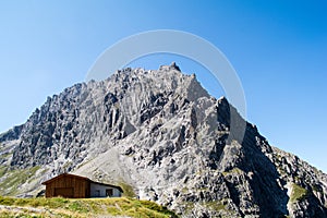 Rocky mountains and green grass With the sun and the beautiful blue sky with clouds