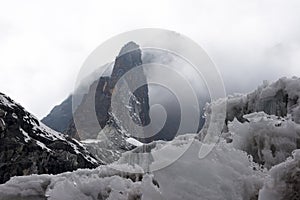 Rocky needle and a glacier at bad weather, Himalaya, Nepal