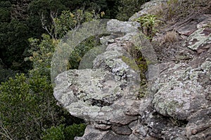 Rocky Outcrop Overlooking Green Forested Valley Below