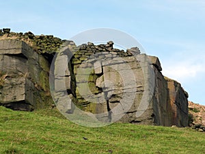 Rocky outcrops boulders and stone walls in yorkshire moorland