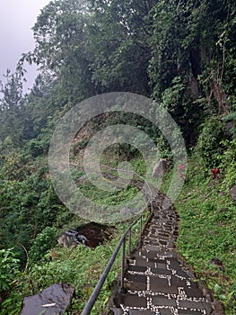 Rocky path on a mountain cliff during a drizzle