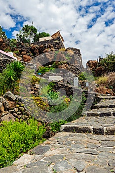 A rocky path up the hill among volcanic stones, Alicudi, Italy.