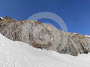 Rocky peak Chrutlenstogg 1966 m with the stone cliff Chrutlenwand in the Glarus Alps mountain range, over the KlÃ¶ntalersee