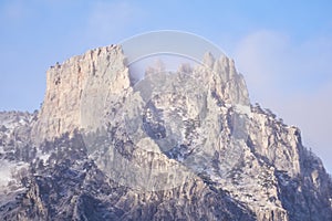 Rocky peak of Mount Ai-Petri against the sky in bright sunlight through a cloudy haze