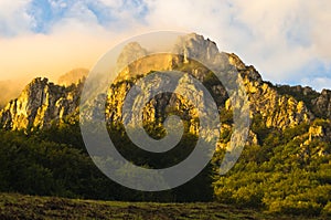 Rocky peaks at foggy sunrise, trekking path at Suva Planina mountain