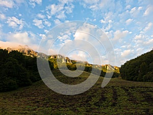 Rocky peaks at foggy sunrise, trekking path at Suva Planina mountain