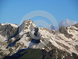 Rocky peaks and stones with snow in Caucasian mountains in Georgia