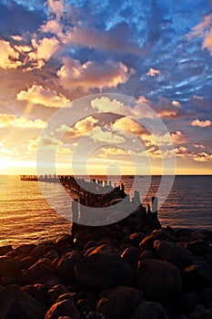 Rocky pier, sunrise, cloudscape