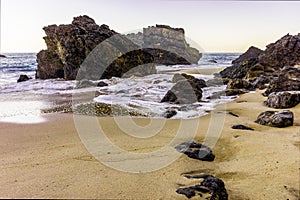 Rocky and sandy beach at sunrise, Portugal