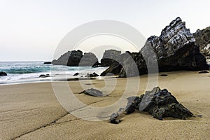 Rocky and sandy beach at sunrise, Portugal