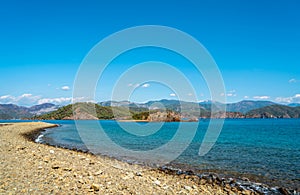 Rocky sea coast line near mountains landscape