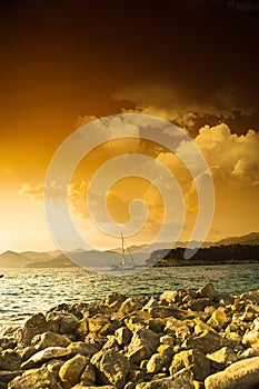 Rocky sea shore and dramatic sky at sunset